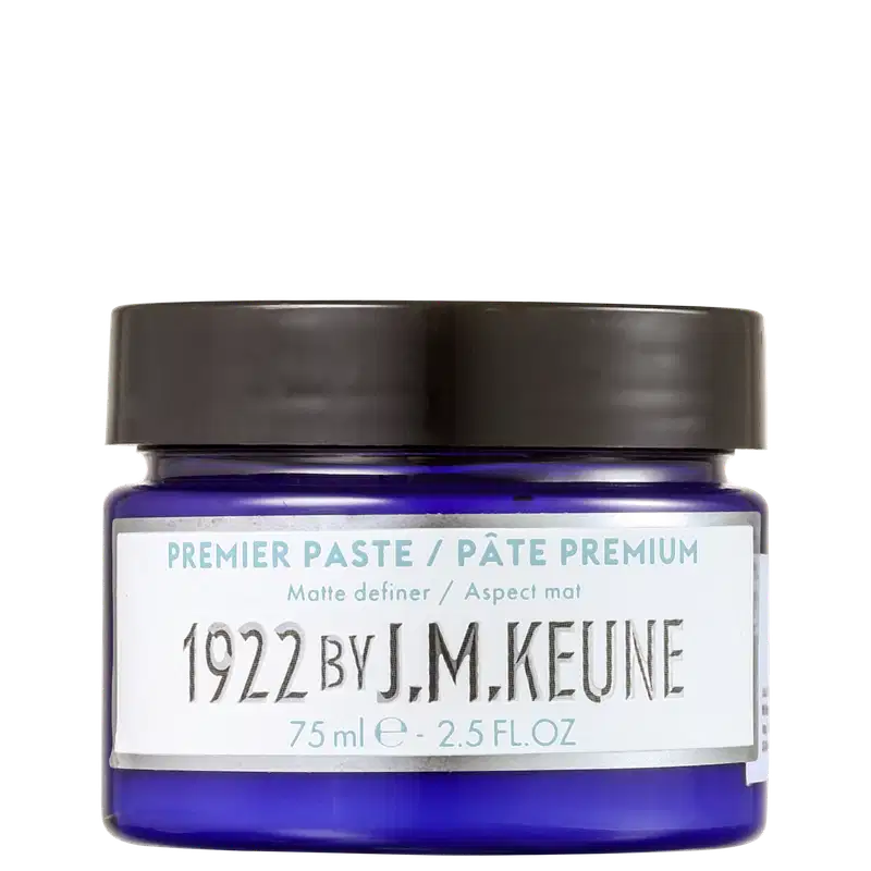 Pote de pasta premium da marca Keune, com tampa preta e rótulo branco contendo informações sobre o produto, incluindo o nome "J.M. Keune" e o volume de 75 ml.
