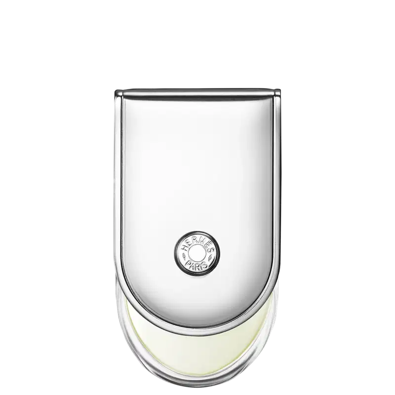 Frasco de perfume Hermès em vidro transparente com tampa arredondada. Rótulo circular com a marca Hermès Paris impresso em preto. Líquido incolor visível no interior do frasco.
