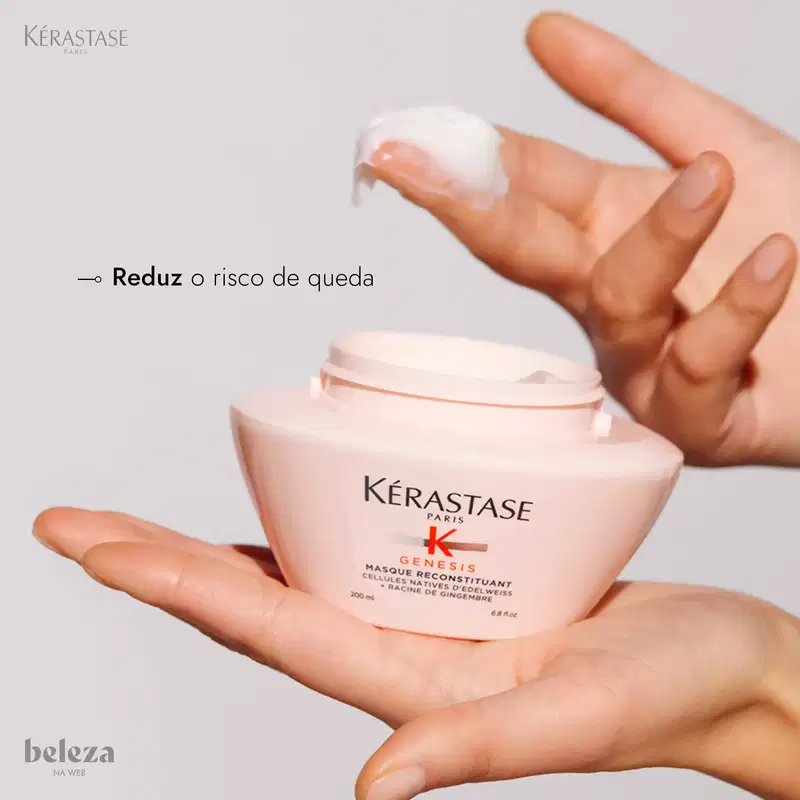 Frasco de creme capilar Kérastase Genesis, com embalagem branca e rosa, contendo texto em português "Reduz o risco de queda" e informações sobre o produto.
