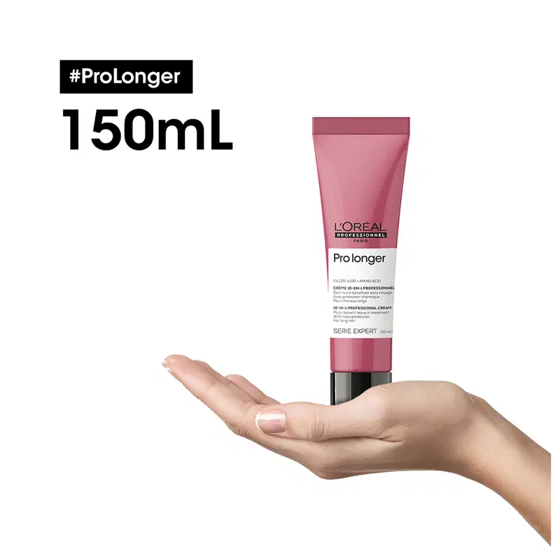 O produto apresentado é um creme de tratamento capilar da linha Pro Longer da L'Oréal Professionnel, em uma embalagem de tubo rosa de 150 mL. O rótulo destaca o nome da linha e a promessa de "maior duração" do tratamento.