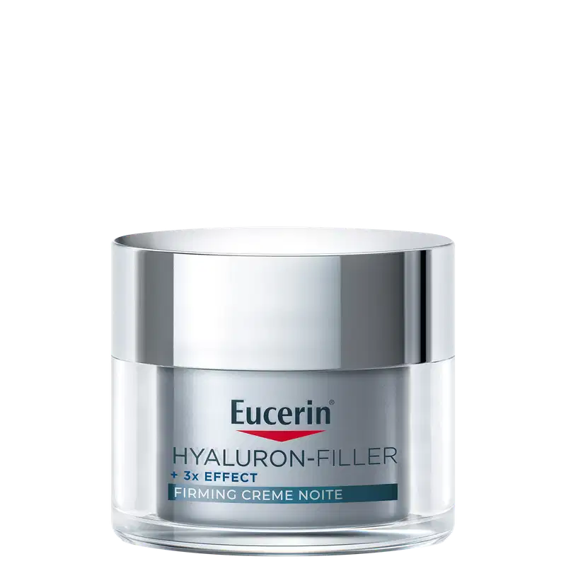 Frasco de creme facial noturno da marca Eucerin, com tampa prateada, rótulo branco e azul, contendo texto "Hyaluron-Filler + 3x Effect Firming Creme Noite".
