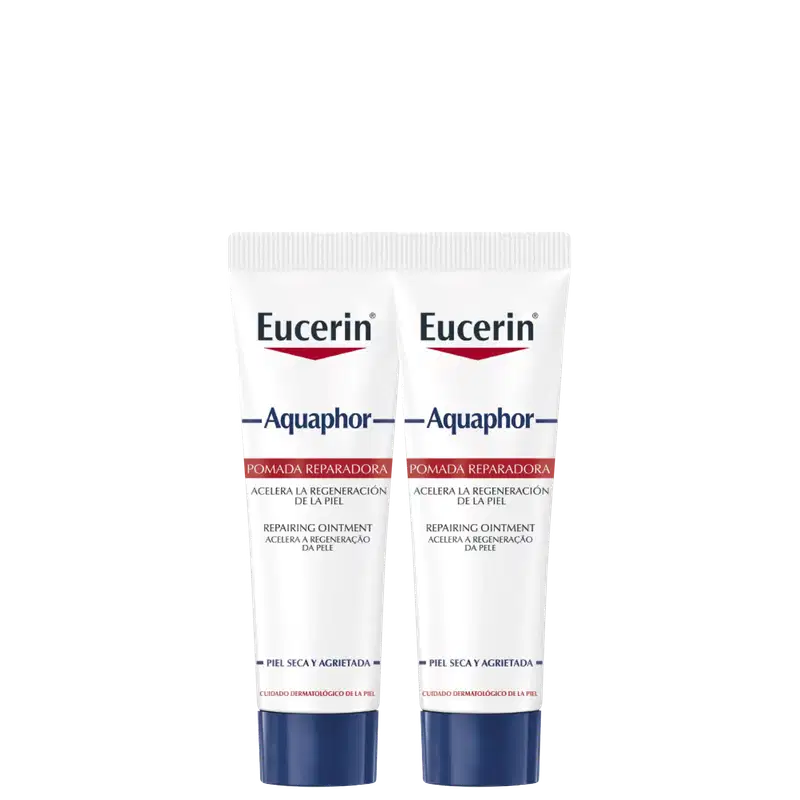 Dois tubos brancos da marca Eucerin contendo pomada reparadora Aquaphor, com rótulos azuis e vermelhos, para cuidados com pele seca e agredida.