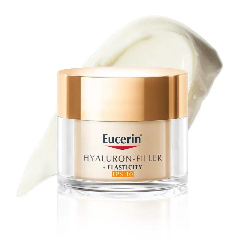 Pote de creme facial branco com tampa dourada da marca Eucerin, contendo textura cremosa e brilhante, com superfície lisa e refletiva.