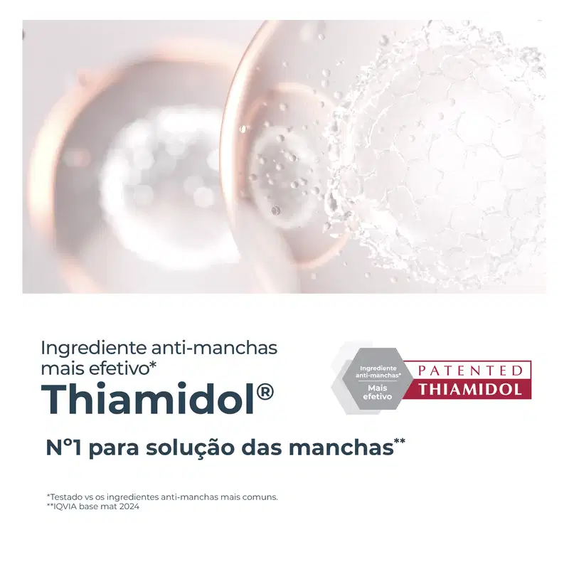 Embalagem de item de perfumaria com ingrediente anti-manchas patenteado Thiamidol, descrito como o mais efetivo para solução de manchas, com texto "Ingrediente anti-manchas mais efetivo" e "Nº1 para solução das manchas".