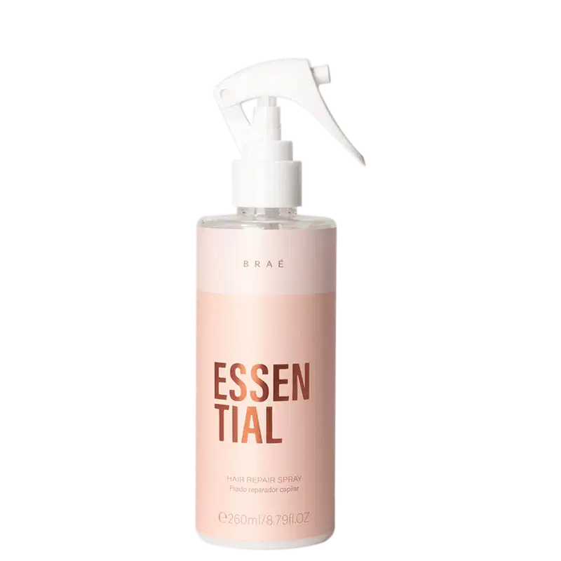 Frasco de spray branco e rosa com rótulo "ESSENTIAL" em letras grandes, contendo fluido reparador capilar da marca Braé.