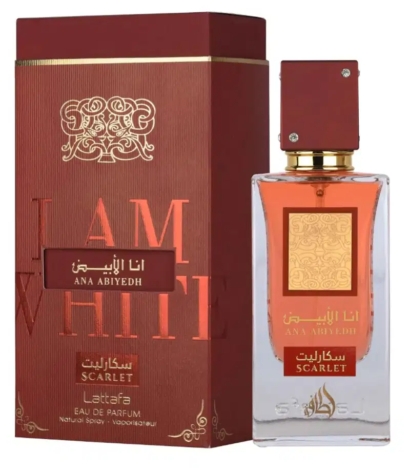 Perfume de luxo da marca Lattafa, em frasco de vidro com tampa dourada, embalado em caixa vermelha com detalhes dourados e texto em árabe e inglês. Produto chamado "Ana Abiyedh" com aroma "Scarlet".