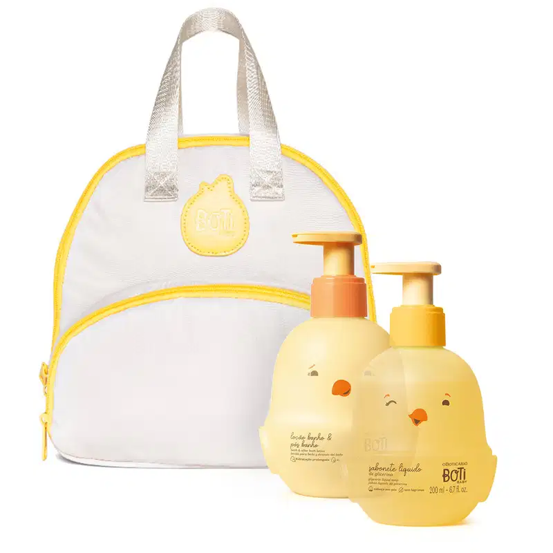 Bolsa branca e amarela com detalhes em amarelo, contendo um frasco de sabonete líquido e um frasco de loção corporal da marca Boti Baby, ambos com embalagem amarela e detalhes gráficos.