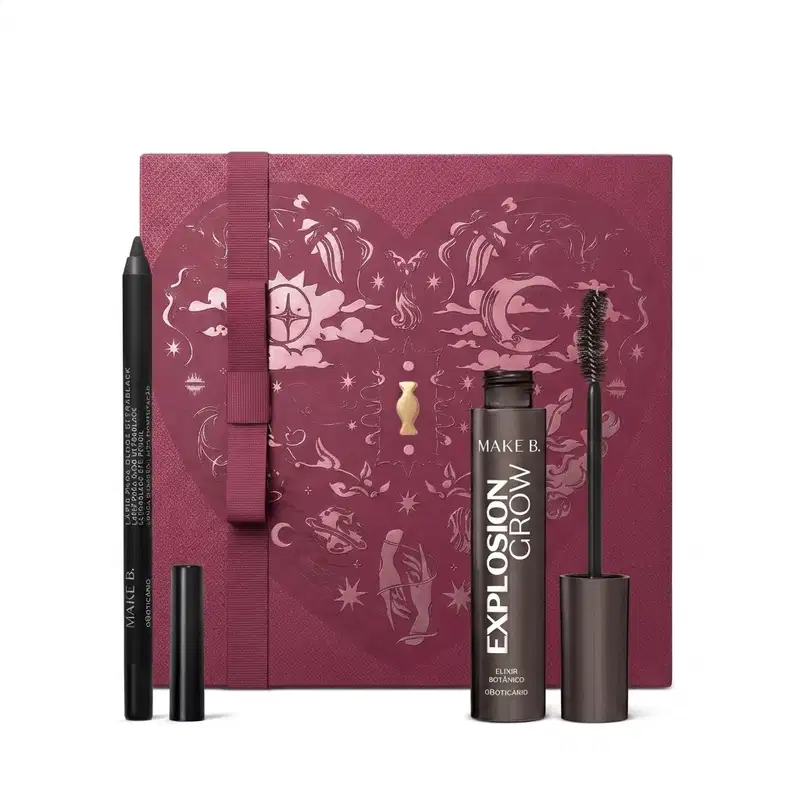 Caixa de presente de cor vinho com um grande coração contendo ilustrações em relevo de temática celestial. Ao lado, dois itens de maquiagem da marca Make B., sendo um lápis para olhos preto e uma máscara de cilios da linha Explosion Crow.