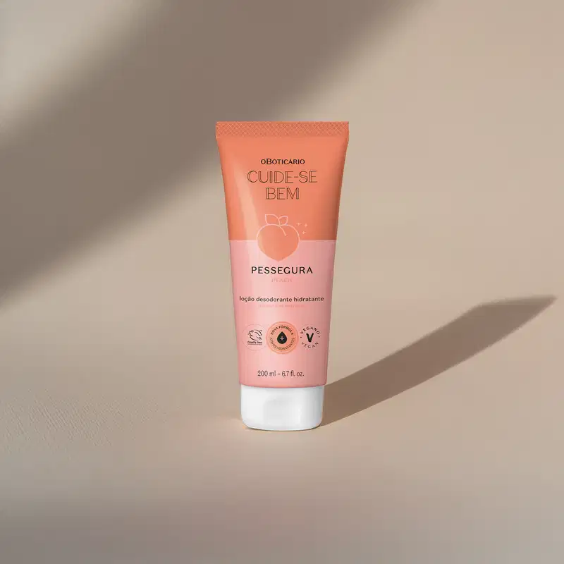 Bisnaga em tons de rosa com tampa transparente, letras pretas e pêssego ilustrado contendo 200ml de loção hidratante corporal da marca Cuide-se Bem Pessegura em fundo bege com sombras.