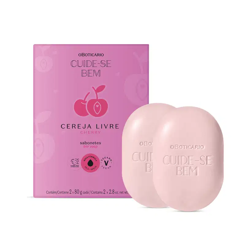 Caixa roxa com letras pretas e cerejas rosa ilustradas ao lado de dois sabonetes em barra brancos em formato ovalado da marca Cuide-se Bem Cereja Livre, contendo 80g cada um.