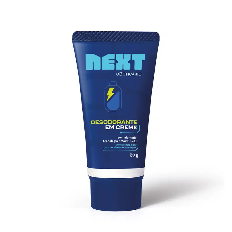 Embalagem azul escura de desodorante em creme da marca Next, com tecnologia SmartShield e sem alumínio, com detalhes em sobretom de azul um pouco mais claro e um ícone de bateria com um raio amarelo dentro.