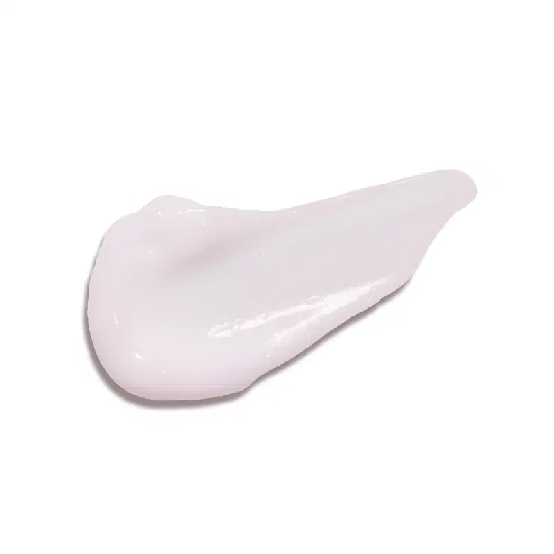 Textura branca, brilhante e cremosa de creme hidratante para mãos Cuide-se Bem Rosa e Algodão em superfície lisa.