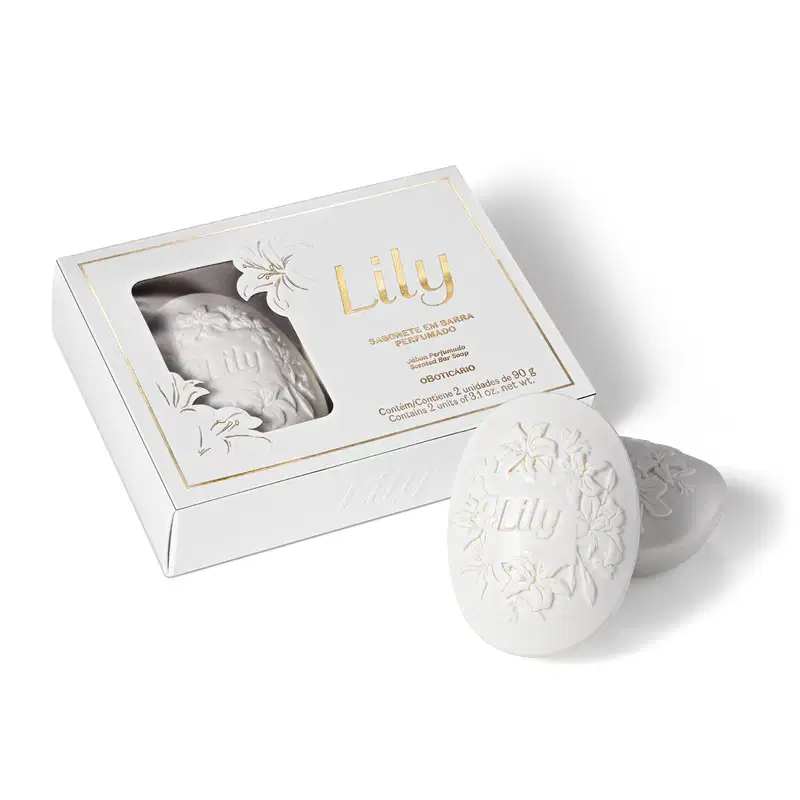 Produto de sabonete em barra perfumado Lily. Embalagem retangular branca com detalhes dourados e impressão floral em relevo. Contém uma barra de sabonete cinza esculpida com o nome "Lily" e motivos florais em relevo.