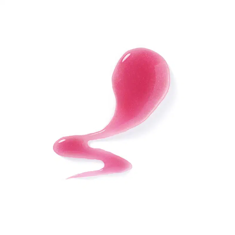 Textura rosada e brilhante do sabonete líquido perfumado espalhada sobre superfície branca formando um pequeno rastro de produto.