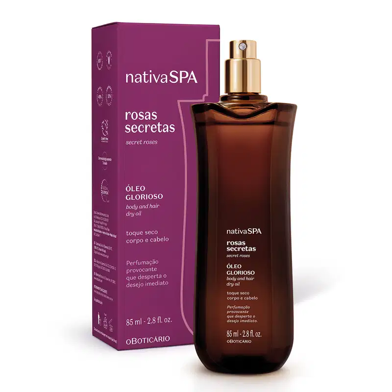 A imagem mostra um frasco roxo de óleo multifuncional da marca Nativa SPA Rosas Secretas. Ele possui borrifador dourado e, logo atrás, está a sua embalagem: uma caixa também roxa. As informações estão em letras brancas e douradas.