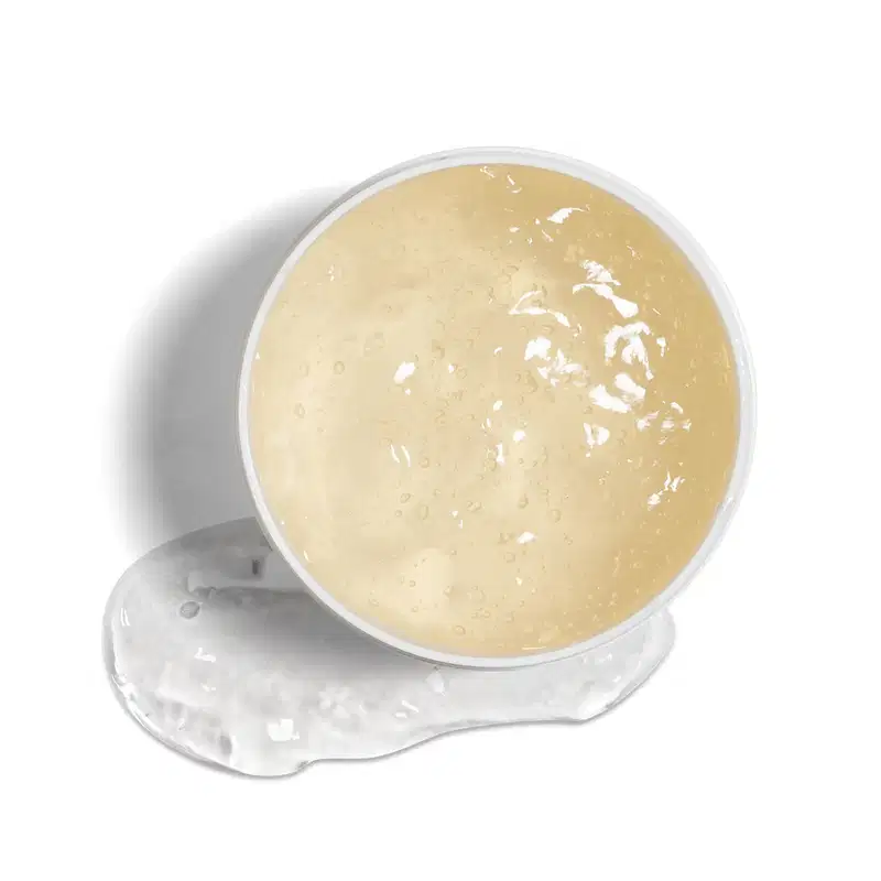 Imagem da textura gelatinosa e translúcida do jelly capilar. Ele possui tom amarelado, com pequenas bolhas e brilho, em recipiente de plástico sobre superfície clara.