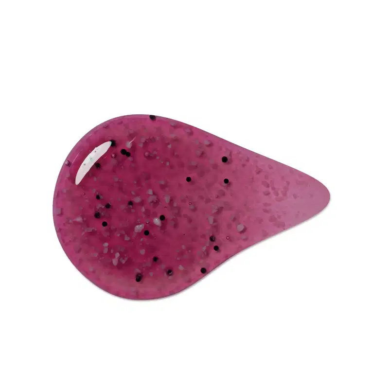 Textura arroxeada, brilhante e granulada de item de sabonete esfoliante corporal, com pequenos pontos.