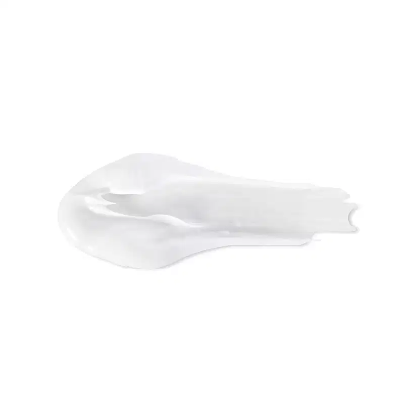 Objeto branco com textura suave e brilhante, com aparência cremosa e delicada. Possui formato irregular e assimétrico, sugerindo tratar-se de um item de  corpo e banho