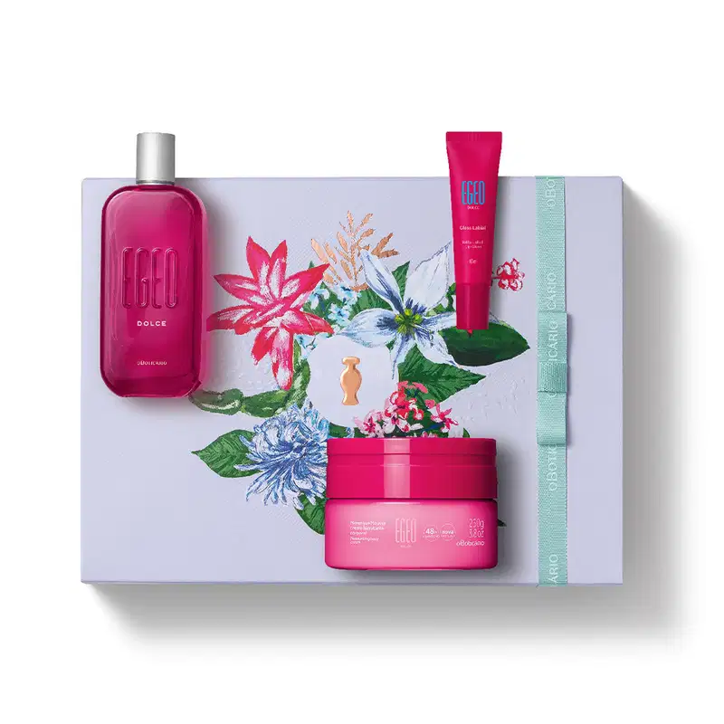 Imagem do kit presente Egeo Dolce com creme hidratante corporal, desodorante colônia com tampa prateada, bisnaga de gloss labial e caixa branca com ilustração floral. As embalagens são em tons de rosa com rótulos em letras brancas.