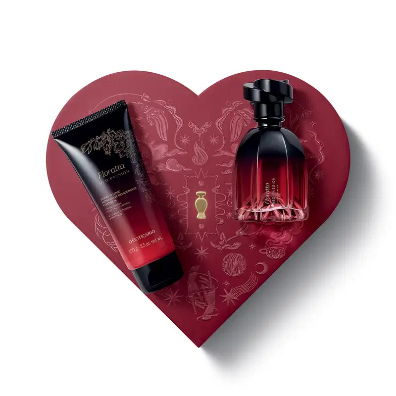 Caixa vermelha em formato de coração com relevo dourado de temática celestial. Sobre ela, um frasco de item de perfumaria  Floratta Red Passion e bisnaga de creme corporal da mesma marca, ambos com embalagem degradê de vermelho para preto e tampa preta.