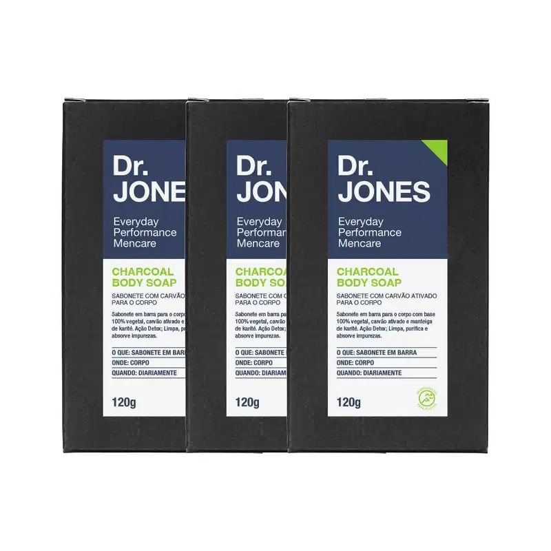 A imagem mostra três sabonetes corporais Dr. Jones. Os sabonetes são pretos, são feitos de carvão ativado e possuem uma embalagem azul e verde de 120g.