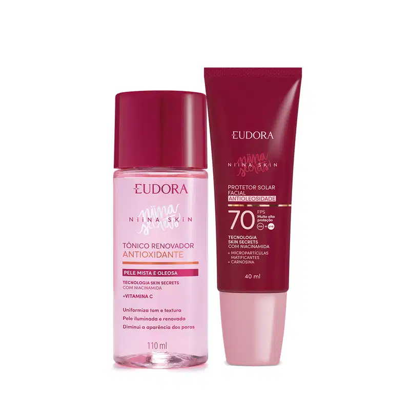 A imagem mostra um kit com dois produtos, lado a lado. Na esquerda, um frasco plástico transparente rosa com tampa vermelha, ao lado de um protetor solar com embalagem toda vermelha e tampa rosa claro.
