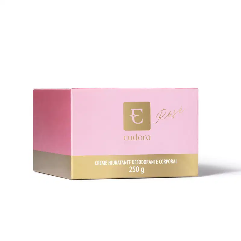 A imagem mostra a caixa do creme hidratante desodorante corporal Eudora Rosé. A embalagem é retangular nas cores rosa e dourado. A caixa exibe o logotipo da Eudora em dourado, bem como o nome do produto e seu peso líquido de 250g.
