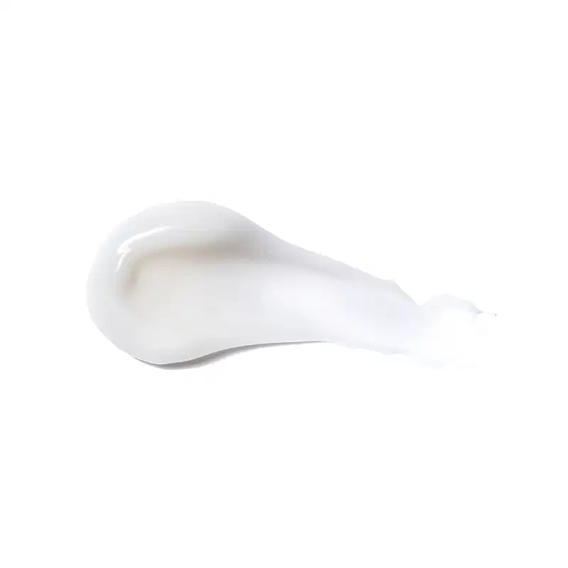 Textura do produto Creme para Pentear - Definição. Possui uma forma arredondada e suave, com uma superfície lisa e brilhante, em uma tonalidade branca. Não há rótulos ou textos visíveis na imagem, apenas a forma do produto em si.