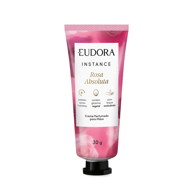 O produto apresentado é um creme perfumado para as mãos da linha Instance Rosa Absoluta. A embalagem é um tubo plástico rosa com rótulo branco que destaca algumas características do produto, como conter glicerina vegetal, ser hidratante e aroma de rosa.