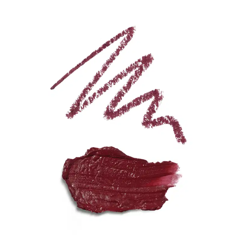 A embalagem não é visível na imagem, que mostra apenas a textura do produto. Na primeira, o risco da lapiseira delineadora e a segunda do batom, ambos na cor malva, com um tom marrom avermelhado profundo.