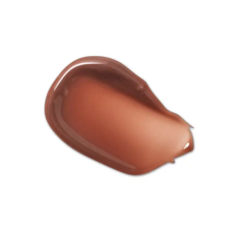 Textura de produto de maquiagem com aspecto cremoso, brilhante e translúcido em tom amarronzado.