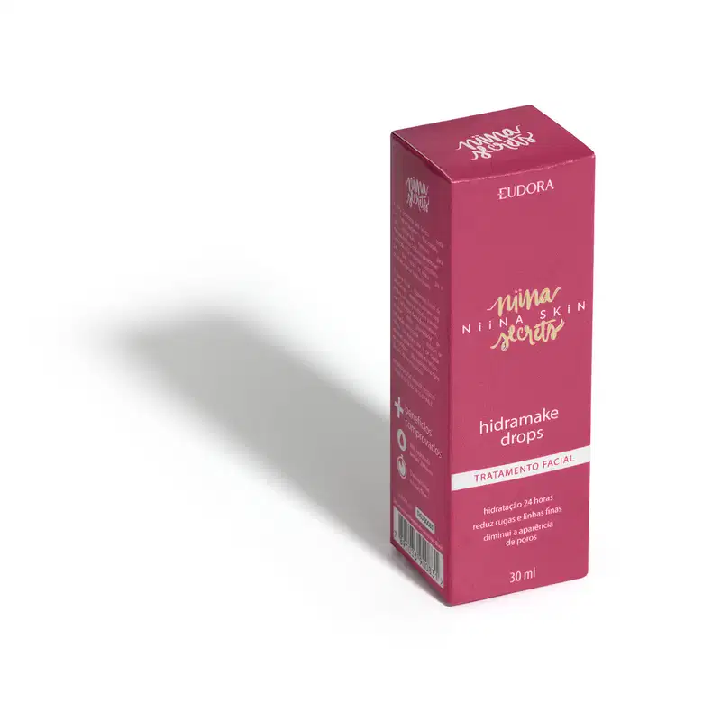Embalagem rosa de Hidramake Drops Tratamento Facial Eudora Niina Skin, frasco de 30ml com texto em dourado e branco, posicionado em perspectiva com sombra.