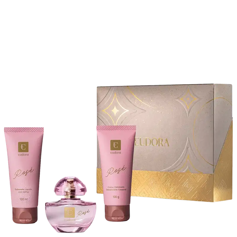 Kit Eudora Rosé contém sabonete líquido com glitter (100ml), perfume em frasco de vidro rosa, creme hidratante desodorante corporal (100g). Embalagem bege com detalhes dourados e padrão geométrico.