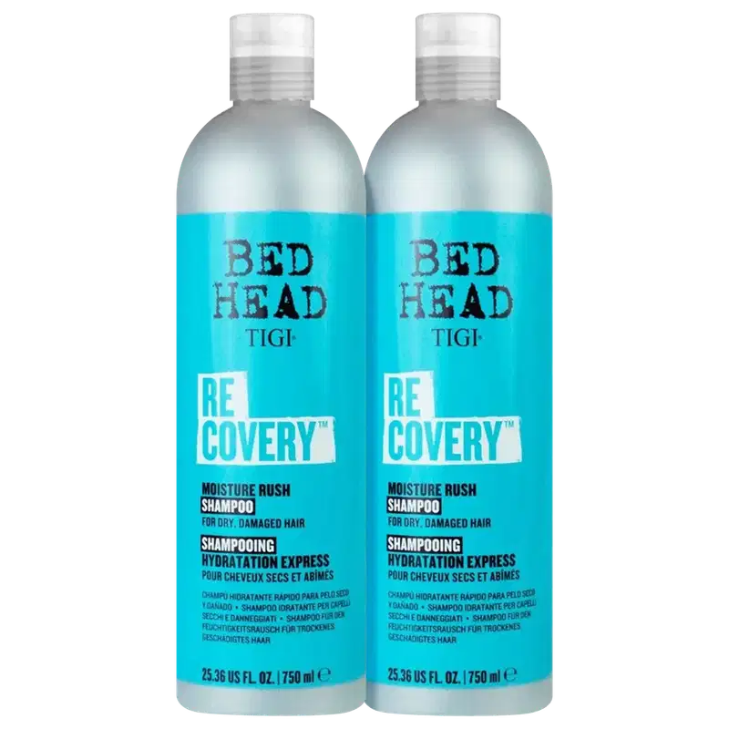 Dois frascos de shampoo TIGI Bed Head Recovery, com embalagem branca e azul, contendo 750 ml cada. O rótulo destaca o nome da linha "Recovery" e a promessa de "Moisture Rush" para cabelos secos e danificados.