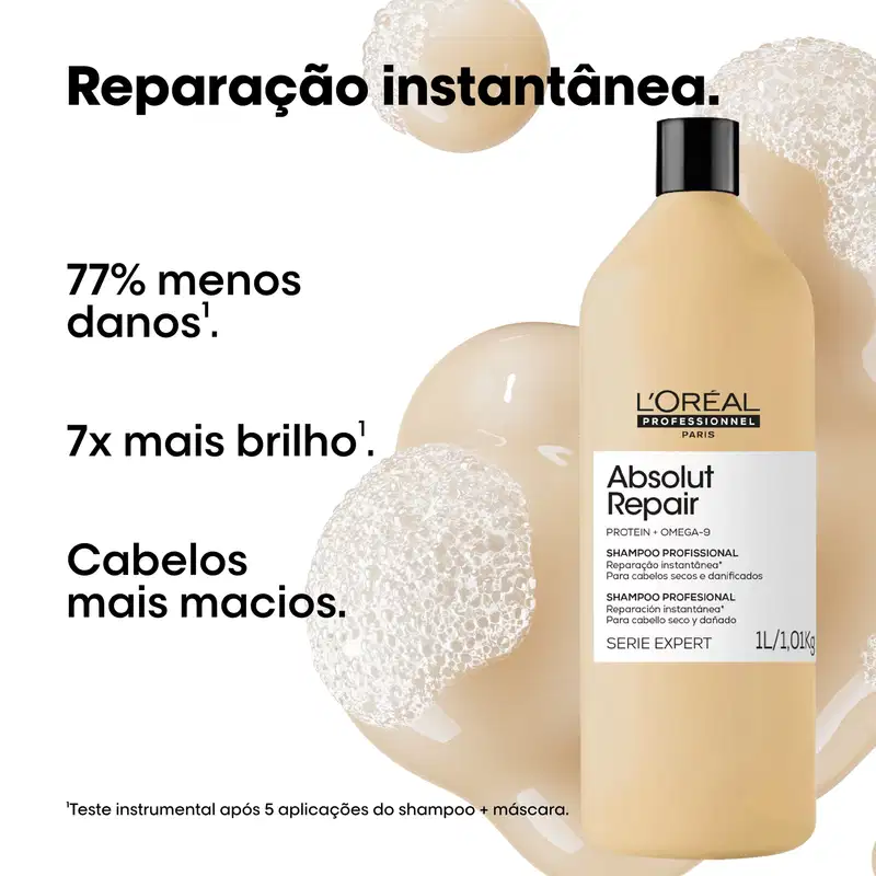 Produto de beleza da L'Oréal Professionnel, embalagem preta e branca, frasco de shampoo com rótulo "Absolut Repair" e informações sobre os benefícios do produto, como reparação instantânea e cabelos mais macios.