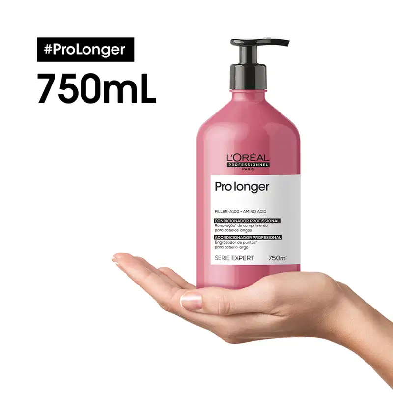O produto é um condicionador profissional da linha Pro Longer da L'Oréal Professionnel, em embalagem de 750 ml com bomba dosadora. A embalagem é predominantemente rosa, com o nome do produto e informações sobre seus benefícios claramente exibidos.
