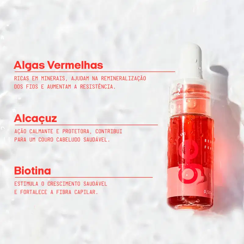 Sérum capilar em frasco de vidro com 50ml, líquido vermelho translúcido, tampa branca com aplicador dropper. Rótulo vermelho com logo circular. Contém algas vermelhas, alcaçuz e biotina para fortalecimento e crescimento capilar.