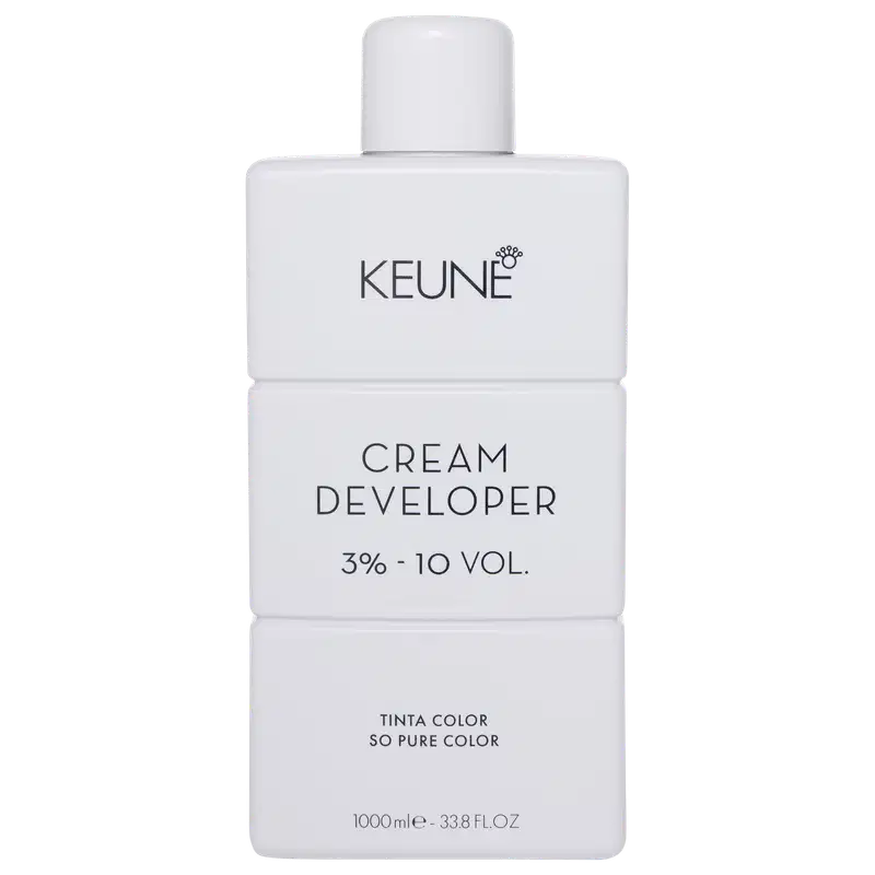 Frasco branco da marca Keune, contendo Cream Developer com 3% - 10 VOL. O rótulo apresenta o nome da marca e do produto em letras pretas.