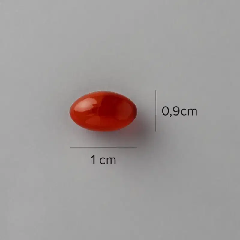 A imagem mostra a cápsula e indicações de medida: 0,9cm x 1cm.