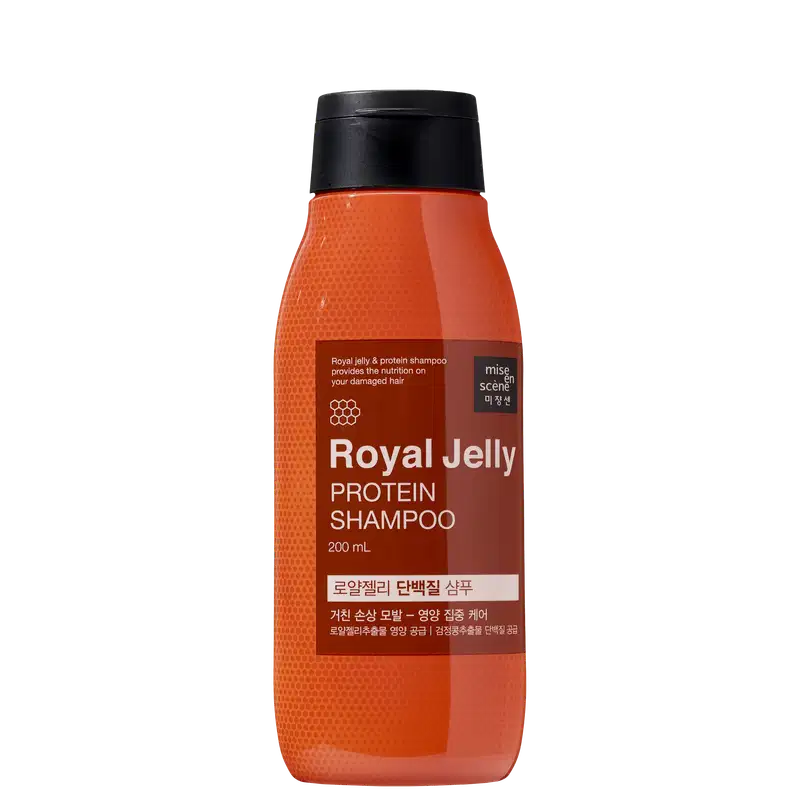Frasco de shampoo de geléia real e proteína da marca Mise en Scène, com 200 ml de capacidade. O recipiente possui uma superfície laranja brilhante, com rótulo em preto e marrom destacando os ingredientes principais.
