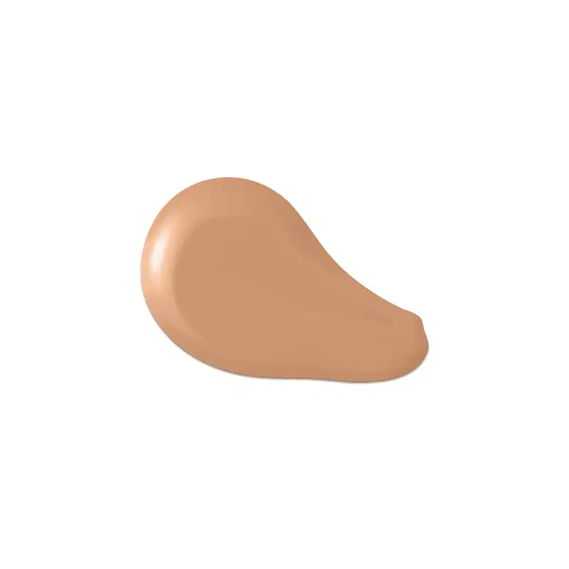 O produto apresentado na imagem é uma base de maquiagem de cor bege escuro, com uma textura cremosa e suave. Sua forma é arredondada e convexa. Não há rótulos, marcas ou outras informações visíveis na imagem.