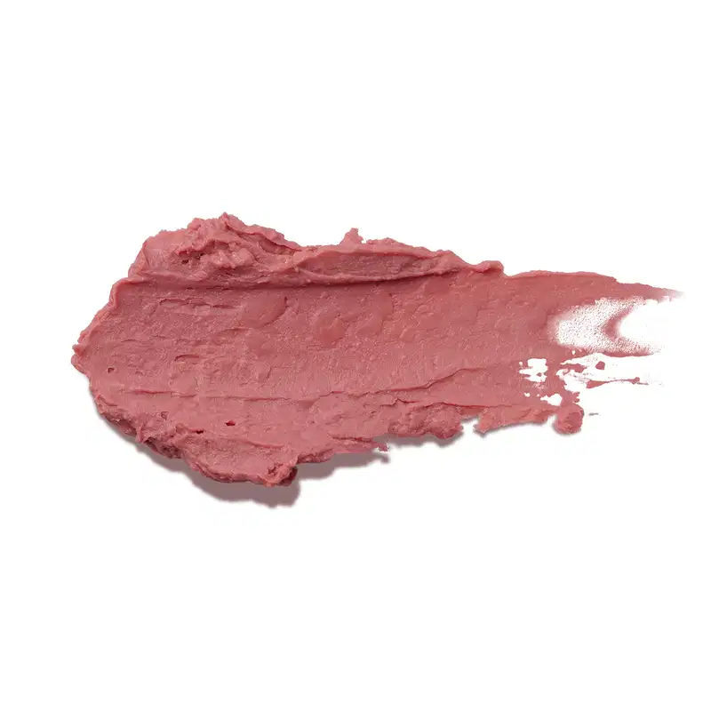 Esta é uma amostra de um balm cremoso de cor rosa escuro. O produto tem uma textura espessa e irregular, formando uma mancha acidentada na superfície. Não há embalagem ou rótulos visíveis na imagem.