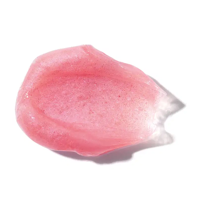 A textura do produto de beleza é semelhante a uma pedra rosa translúcida, com uma superfície brilhante e irregular, sugerindo uma consistência gelatinosa e macia.