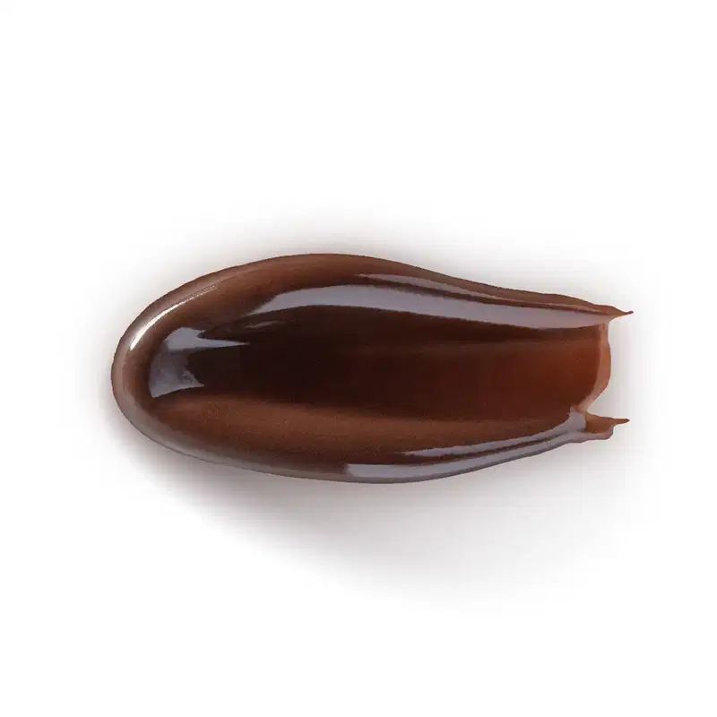 A textura deste produto de beleza é cremosa, com um brilho escuro e acetinado. Sua consistência é suave e sedosa, com uma aparência viscosa e fluida.