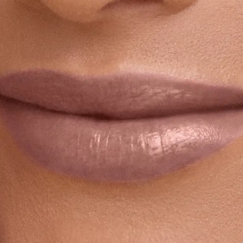 Imagem de close-up de lábios com aplicação de batom rosado, sugerindo um produto de maquiagem para realçar a beleza dos lábios em um ambiente de uso pessoal.