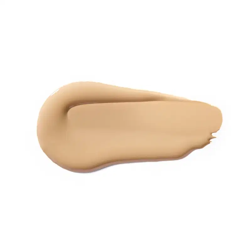Textura cremosa e suave, com tonalidade bege clara e aspecto uniforme, típica de um produto de base ou corretivo da marca Vult.