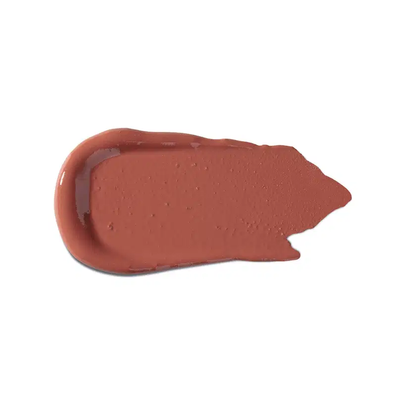 Textura cremosa e uniforme, com tonalidade marrom avermelhada característica de um produto de beleza da marca Vult. Apresenta superfície lisa e brilhante, sugerindo uma consistência macia e deslizante.