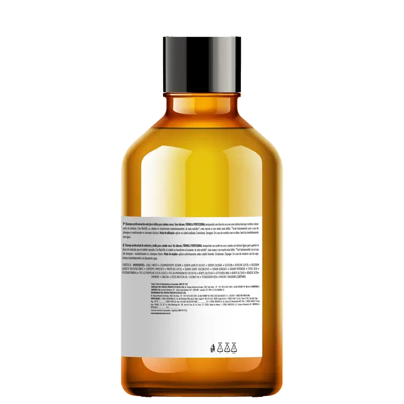 O item de perfumaria é um frasco de vidro âmbar com tampa preta. O rótulo exibe informações sobre o produto em diferentes idiomas. O líquido dentro do frasco possui uma coloração amarelo-dourada brilhante.