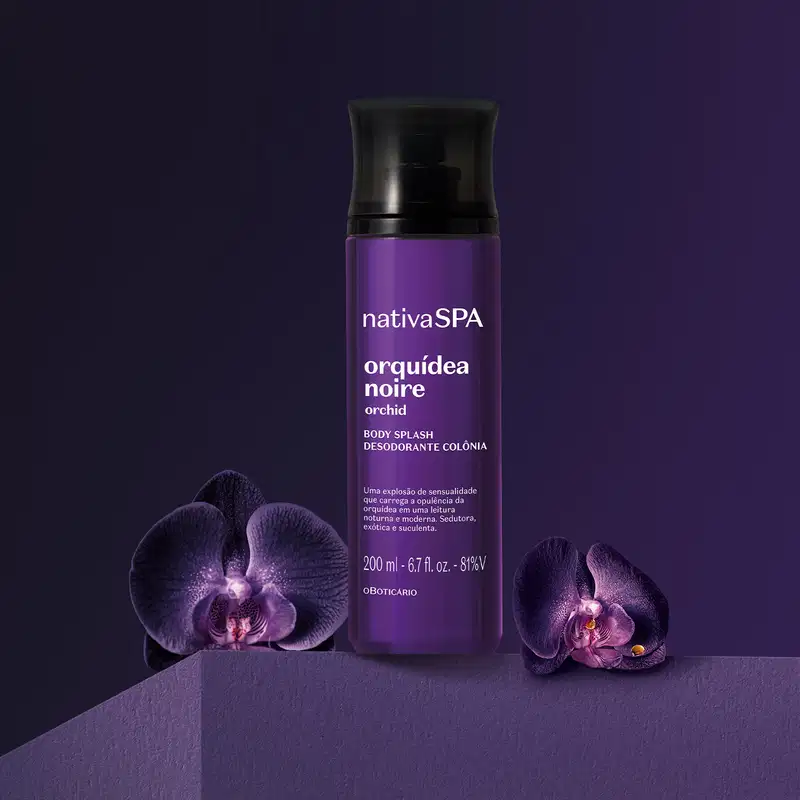 Frasco roxo escuro com tampa preta e letras brancas de body splash da marca Nativa SPA Orquídea Noire em um fundo escuro com orquídeas negras ao redor.