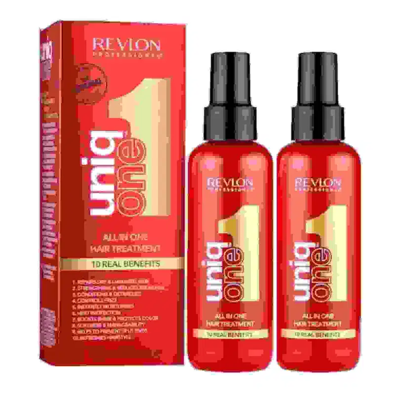 Dois leave-ins da linha Uniq One da marca Revlon Professional. Há uma caixa retangular vermelha com detalhes em branco e dourado, listando os 10 benefícios do tratamento.